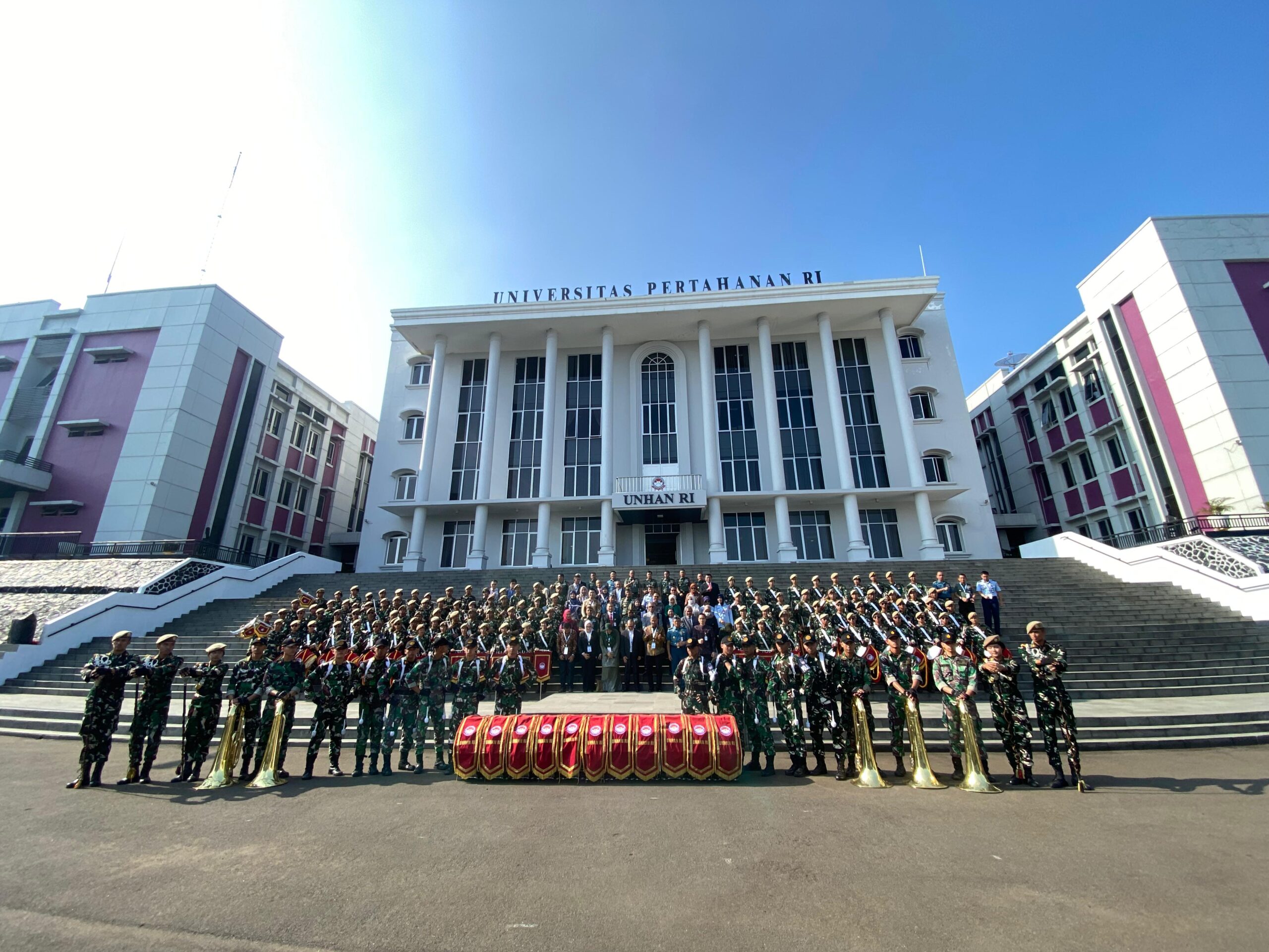 Tamu undangan berfoto bersama para kadet usai atraksi drumband di gedung rektorat yang ikonik scaled