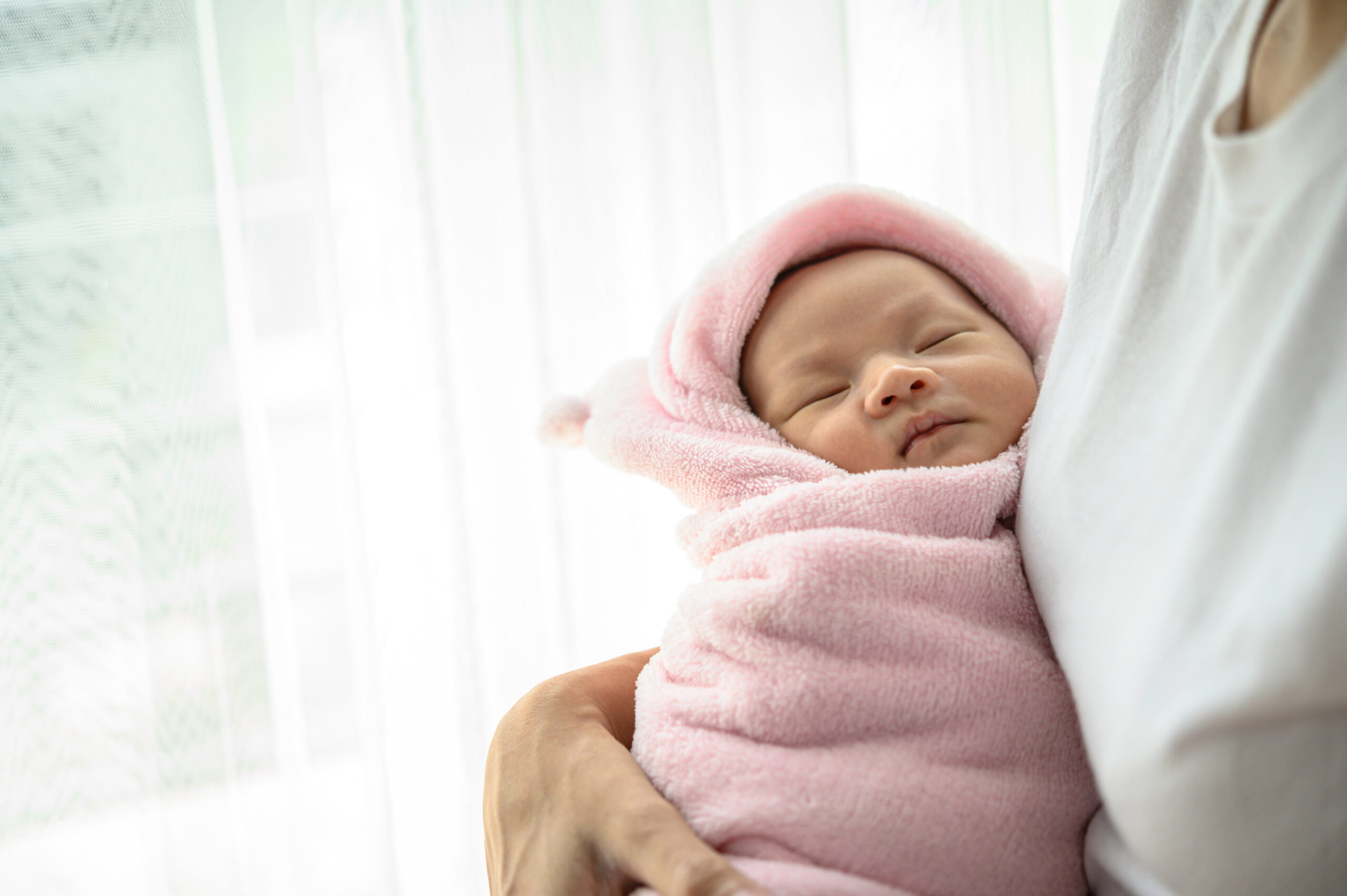 newborn baby sleeping embrace mother scaled