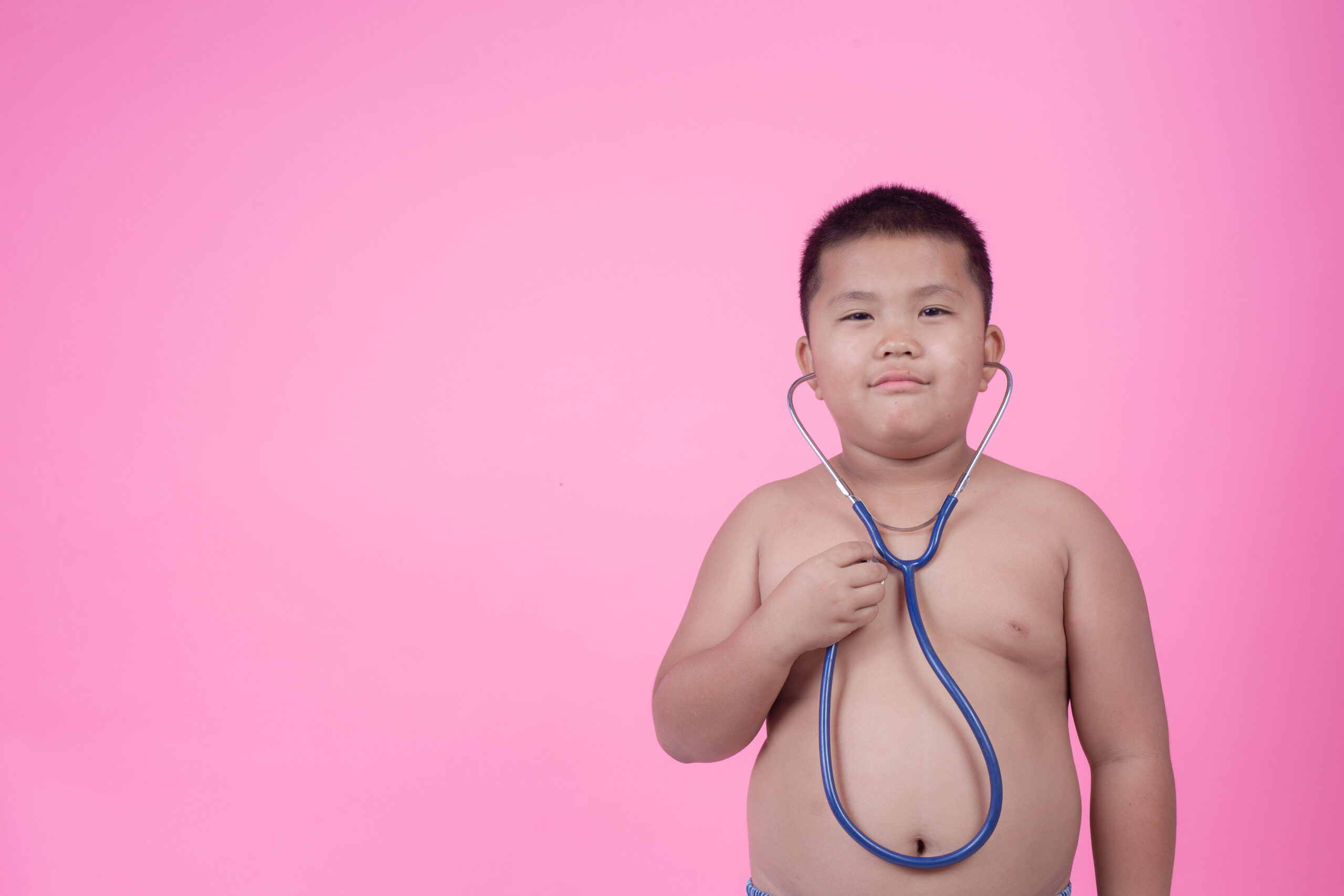 obese boy who is overweight pink background scaled